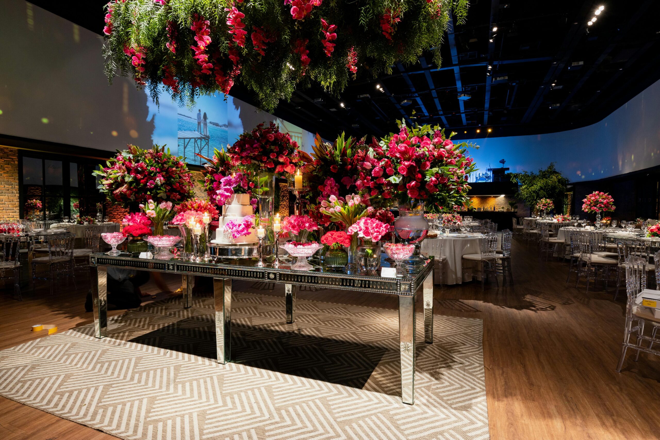 Lavishly decorated indoor wedding venue with vivid red floral arrangements and a sophisticated ambiance.