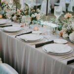 Beautifully decorated wedding reception table with floral arrangements and elegant tableware.
